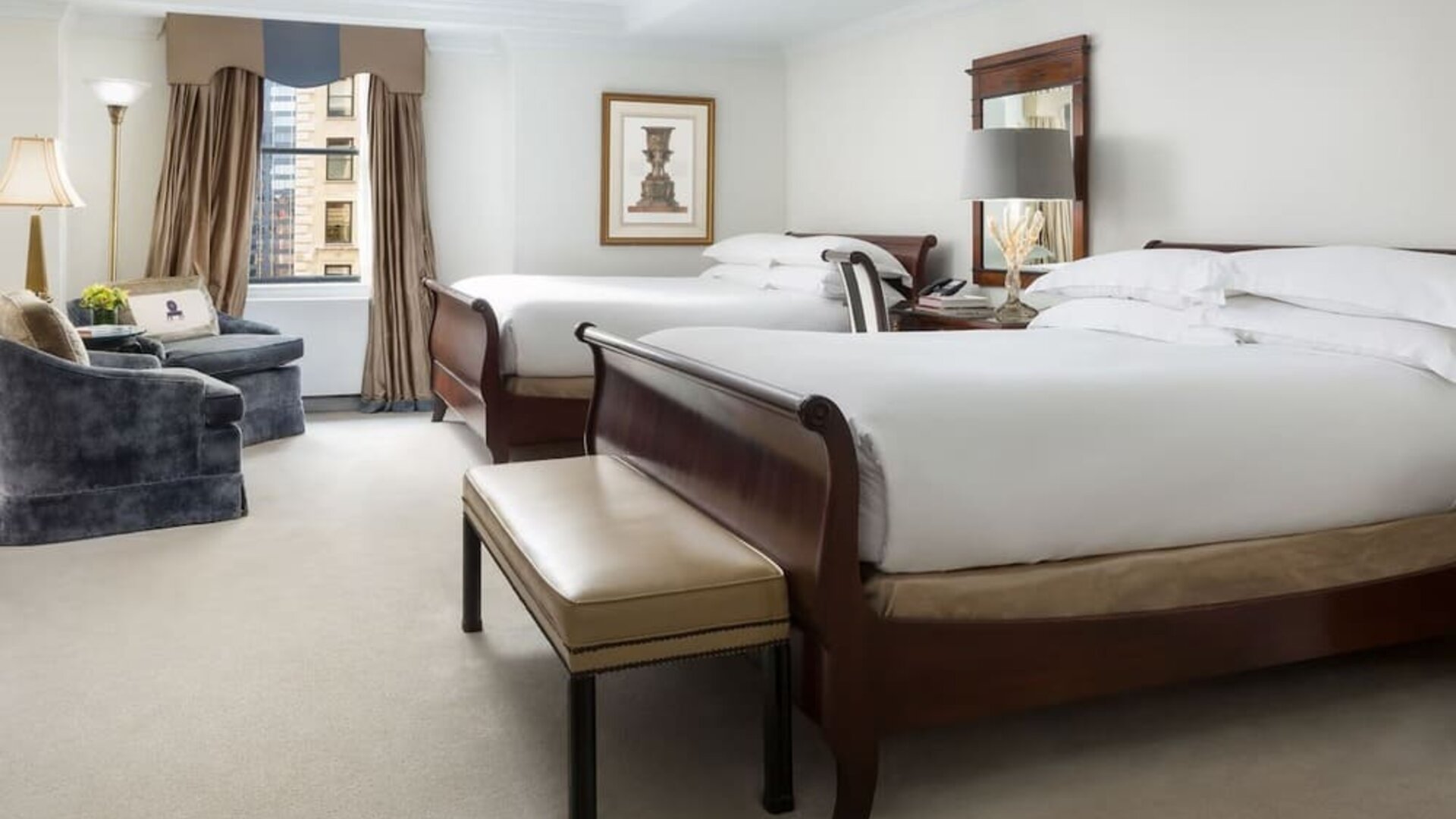 Two-bed guest room with classic furnishings, city views, and ample space at The Michelangelo New York.