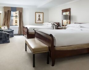 Two-bed guest room with classic furnishings, city views, and ample space at The Michelangelo New York.
