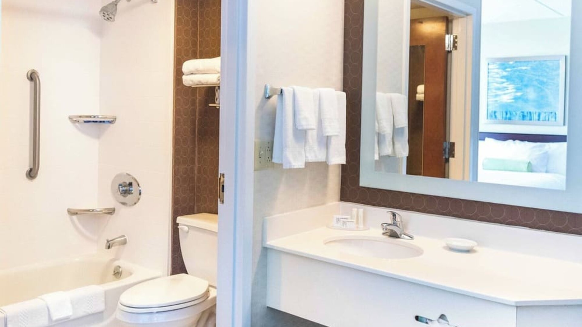 Bathroom at Marriott SpringHill Suites Naperville/Warrenville with tub shower combo, white vanity, and large mirror.