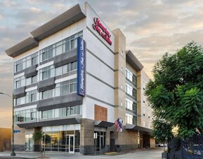 Exterior view of the hotel building with modern façade and signage at Hampton Inn & Suites Los Angeles / Hollywood.