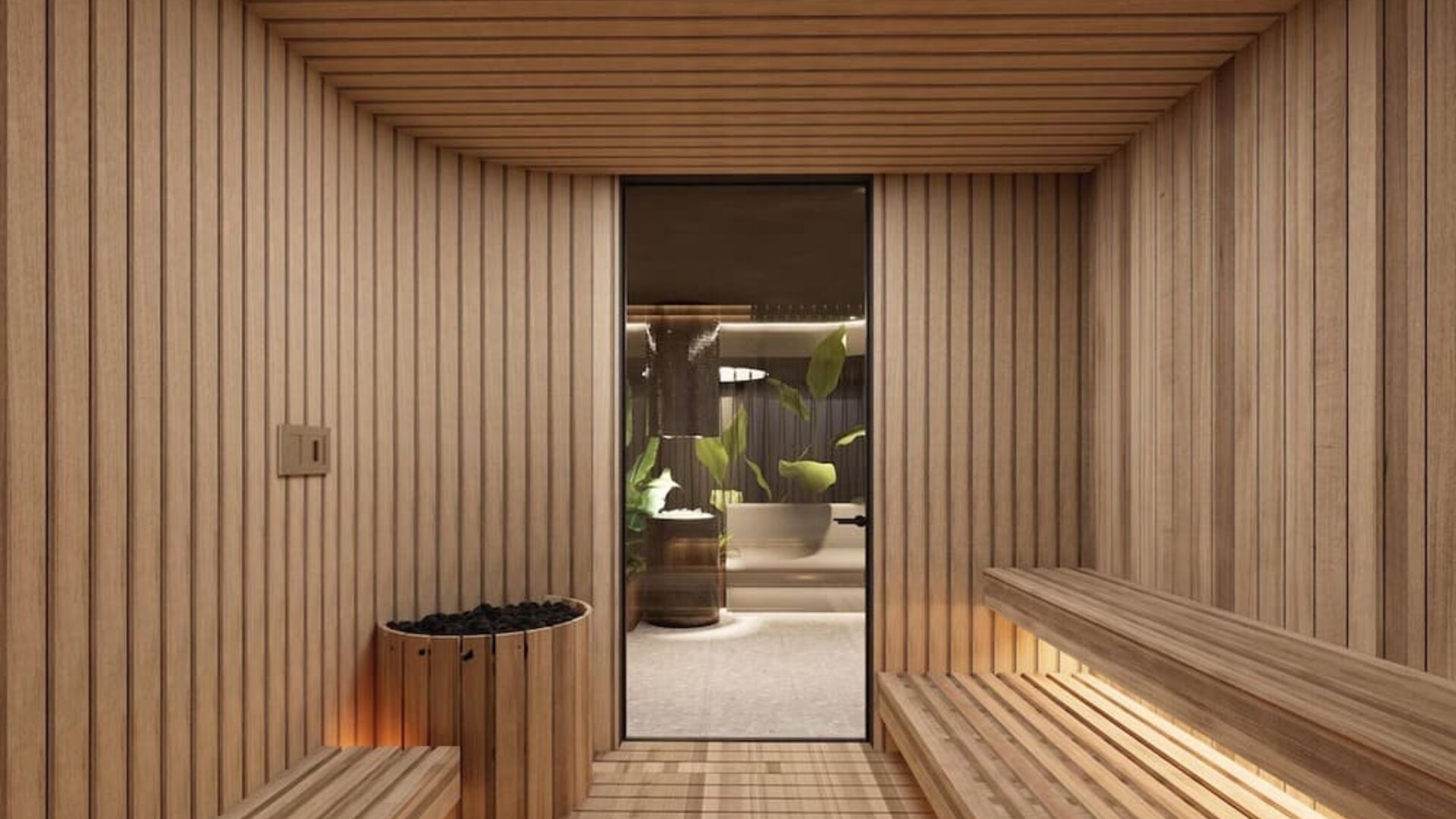 Wood-lined sauna room with bench seating, heated stones, and doorway to adjacent spa area