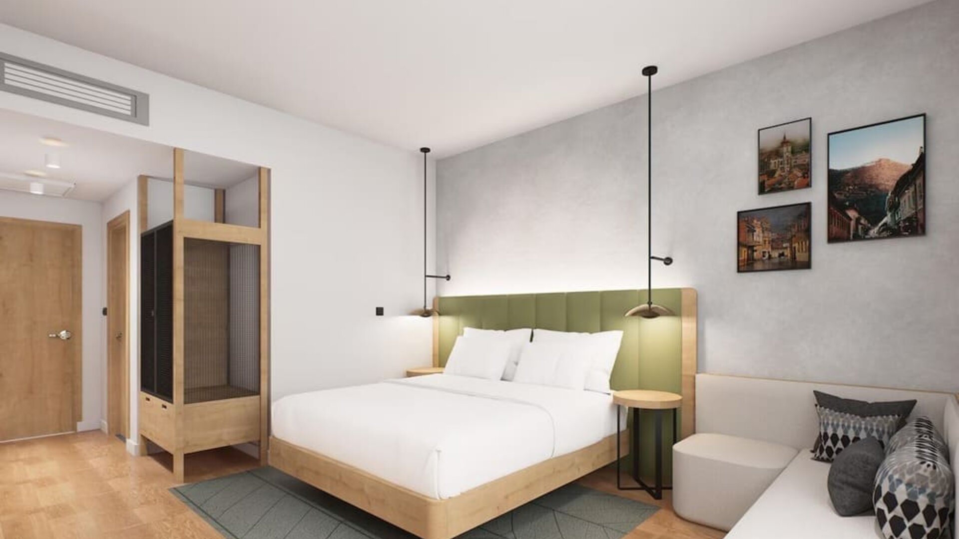 King guest room with green upholstered headboard, wood accents, pendant lights, and small sofa