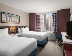 Double queen room with city view and desk at Hilton Garden Inn New York/West 35th Street.