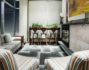Cozy lobby lounge with fireplace at Hilton Garden Inn New York/West 35th Street.