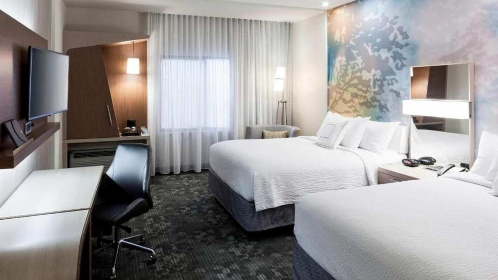 Double queen guest room with modern décor at Courtyard By Marriott Houston North/Shenandoah.