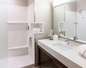 Modern accessible bathroom with walk-in shower at Courtyard By Marriott Houston North/Shenandoah.