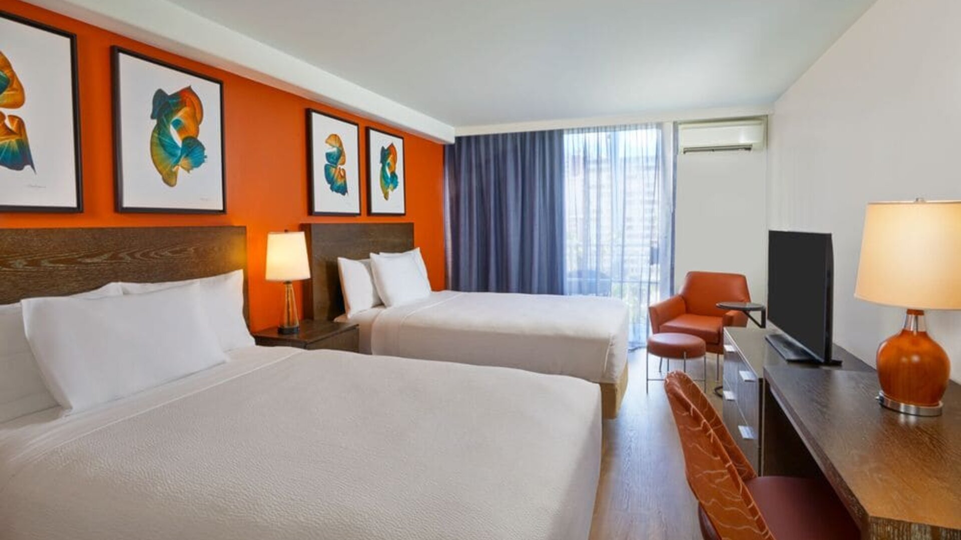 Double queen guest room with contemporary décor at Courtyard Waikiki Beach.