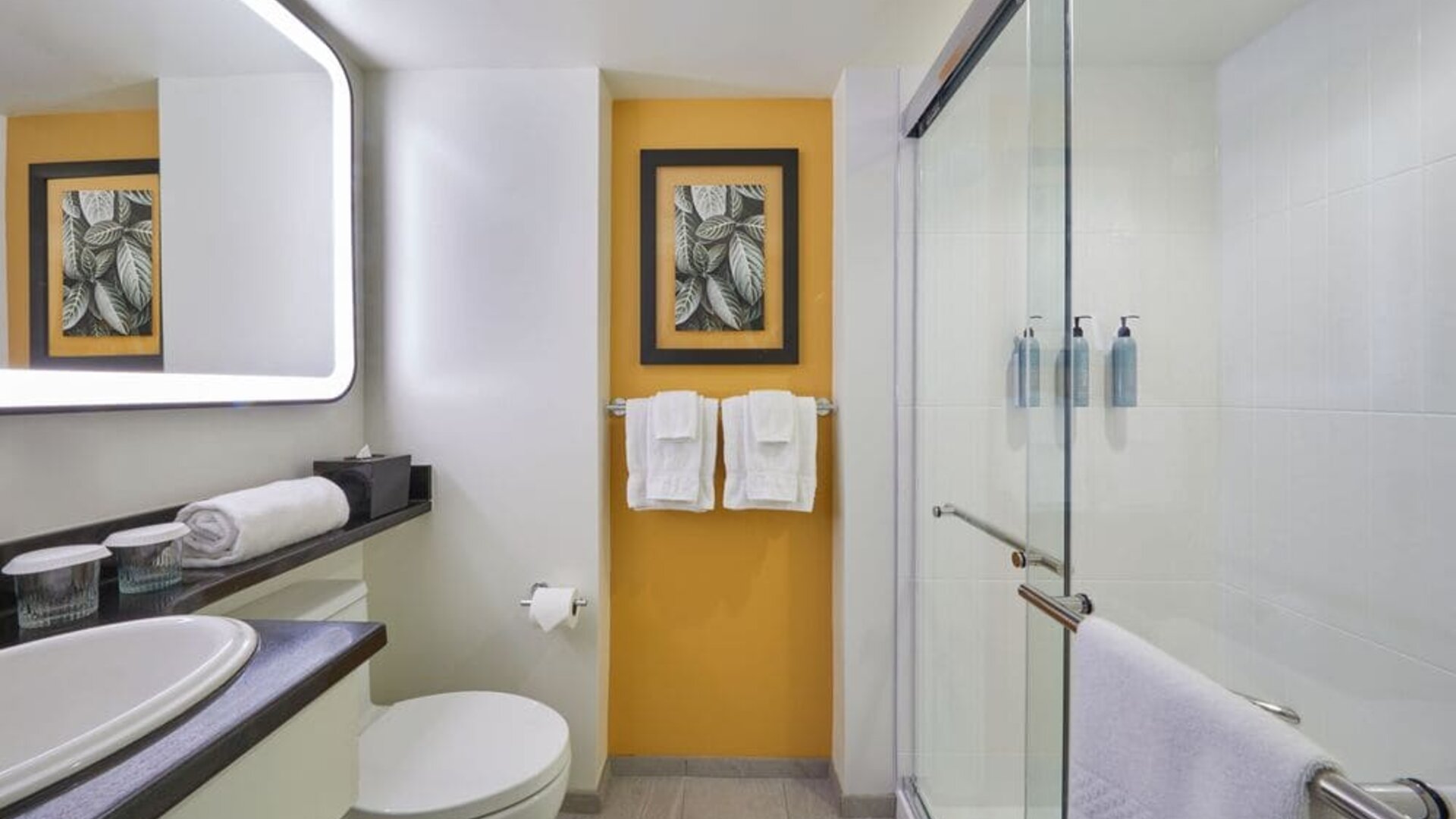 Modern bathroom with walk-in shower at Courtyard Waikiki Beach.
