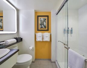 Modern bathroom with walk-in shower at Courtyard Waikiki Beach.