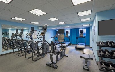 Fitness center with cardio and weight equipment at Courtyard Waikiki Beach.