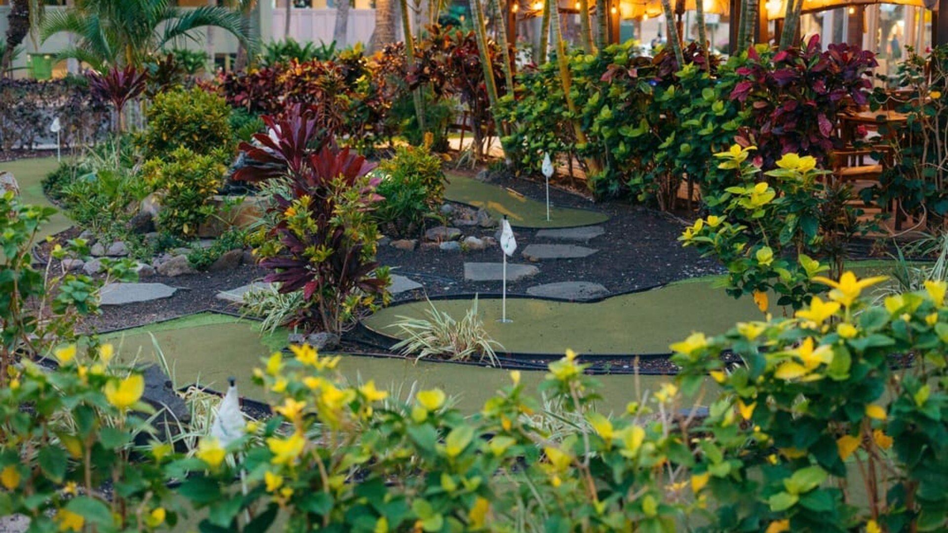 Lush mini golf garden area at Courtyard Waikiki Beach.