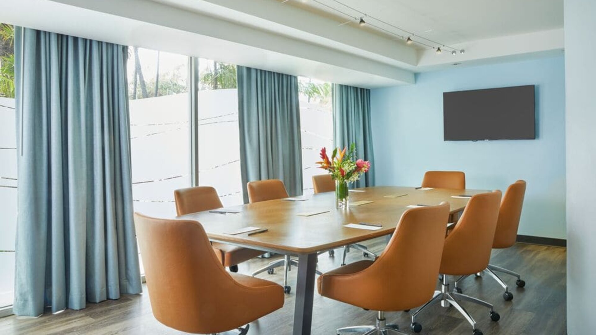 Modern meeting room with large windows at Courtyard Waikiki Beach.