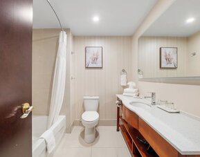 Modern bathroom with large vanity and bathtub at Hotel Montreal Metropolitan, An Ascend Collection Hotel.