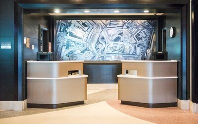 Modern reception desk and lobby area at Courtyard By Marriott New York JFK Airport.