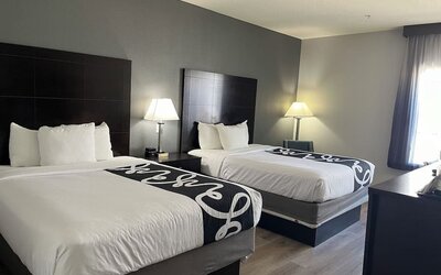 Guest room with two double beds and modern décor at La Quinta Inn & Suites By Wyndham Houston Energy Corridor.