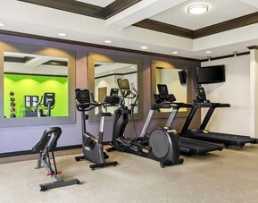 Fitness center with cardio equipment and workout space at La Quinta Inn & Suites By Wyndham Houston Energy Corridor.
