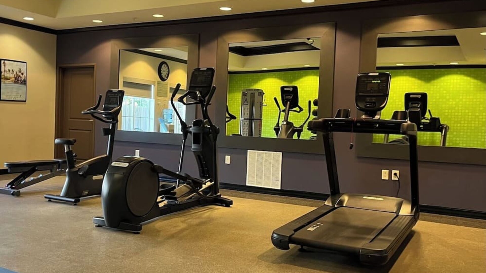 Hotel gym with treadmills, elliptical machines, and fitness equipment at La Quinta Inn & Suites By Wyndham Houston Energy Corridor.