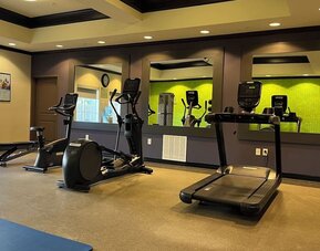 Hotel gym with treadmills, elliptical machines, and fitness equipment at La Quinta Inn & Suites By Wyndham Houston Energy Corridor.