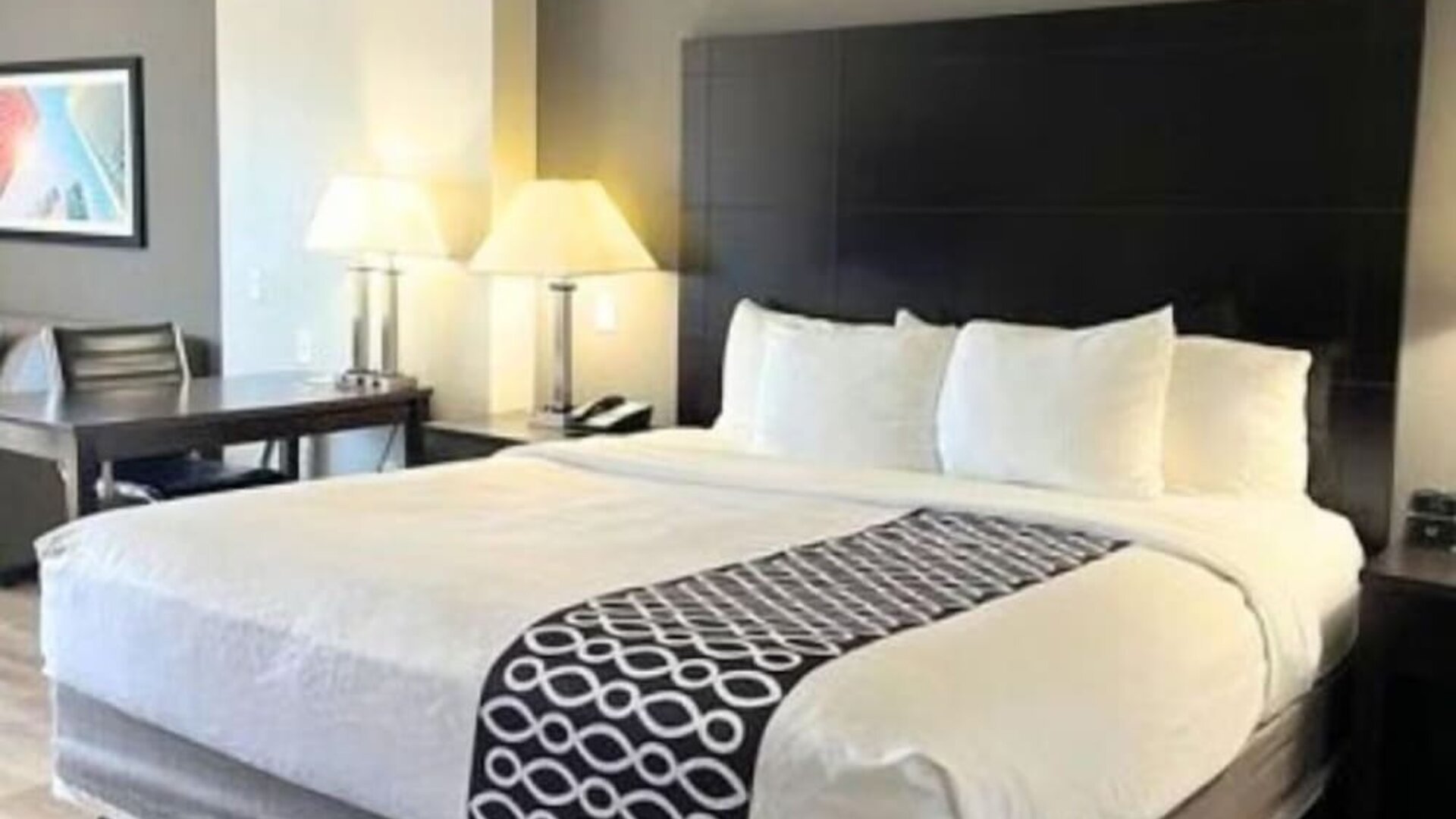 Spacious king room with seating area and modern furnishings at La Quinta Inn & Suites By Wyndham Houston Energy Corridor.
