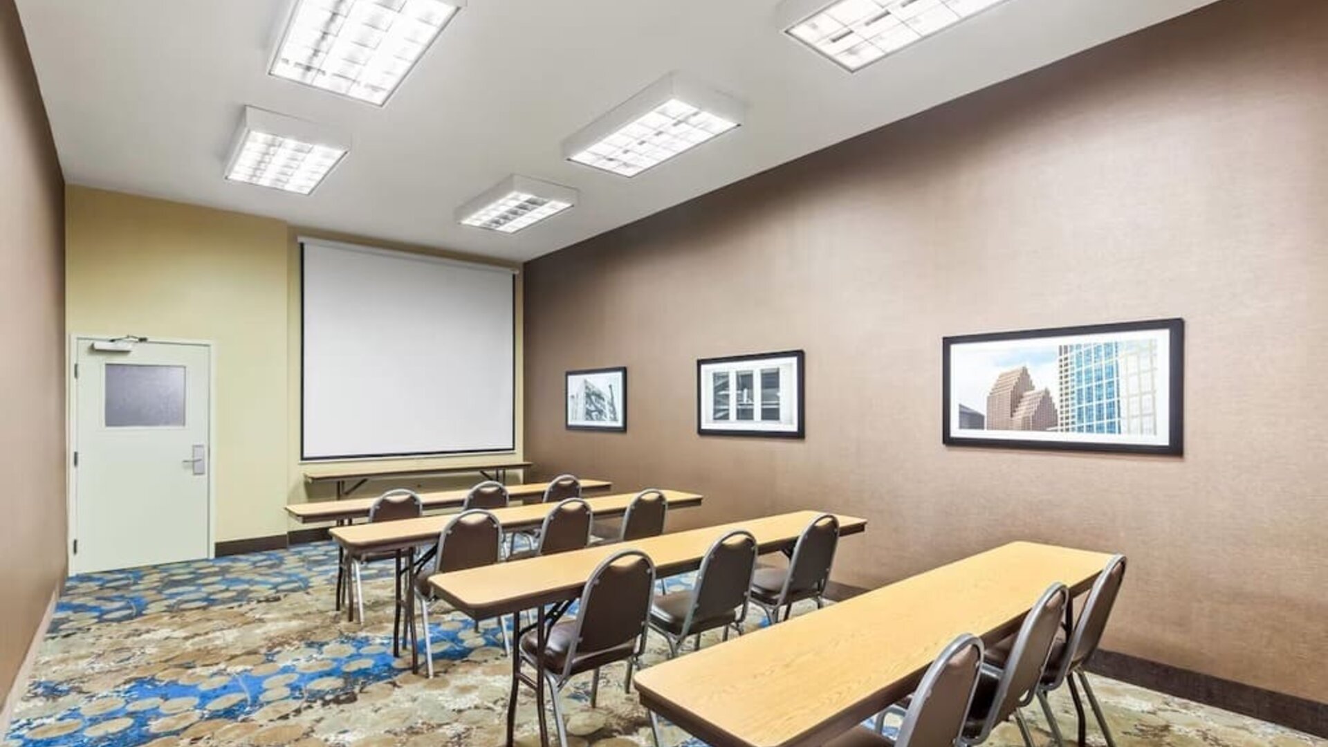 Meeting room with classroom-style seating and presentation screen at La Quinta Inn & Suites By Wyndham Houston Energy Corridor.
