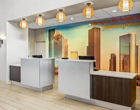 Reception desk and check-in area at La Quinta Inn & Suites By Wyndham Houston Energy Corridor.