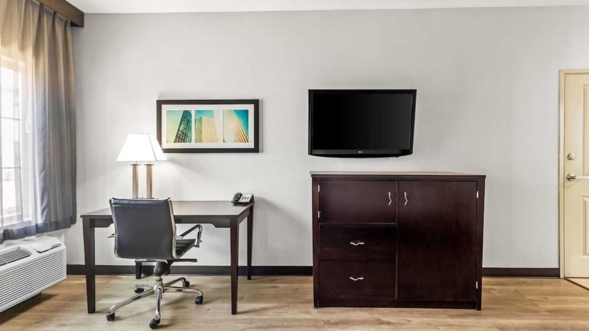 In-room workspace with desk and television at La Quinta Inn & Suites By Wyndham Houston Energy Corridor.