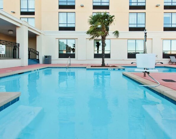 Outdoor pool area with lounge seating at Holiday Inn Downtown Shreveport.