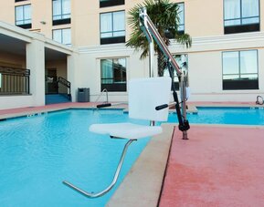 Outdoor swimming pool with accessibility lift at Holiday Inn Downtown Shreveport.