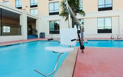 Outdoor swimming pool with accessibility lift at Holiday Inn Downtown Shreveport.