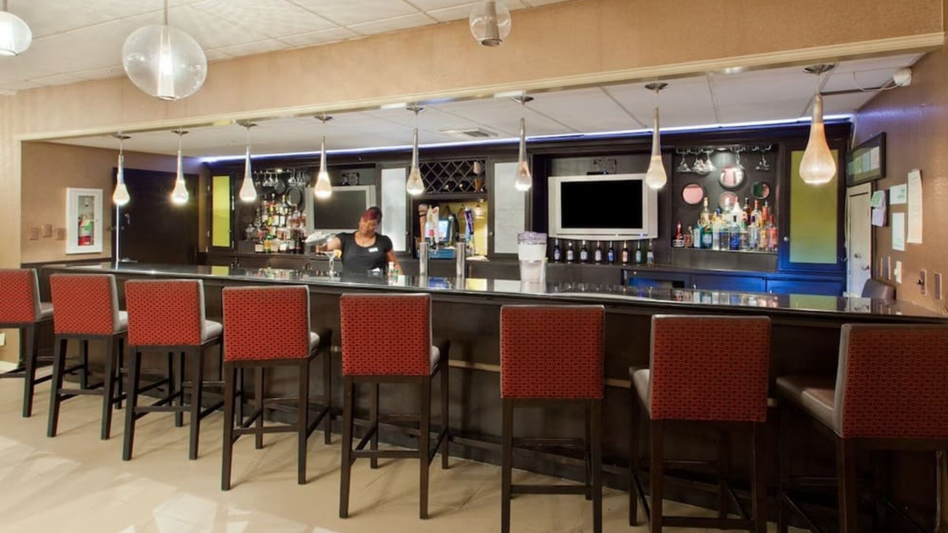 Hotel bar and lounge area with high-top seating at Holiday Inn Downtown Shreveport.