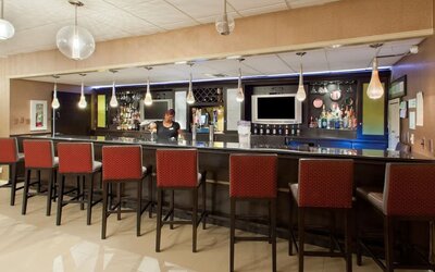 Hotel bar and lounge area with high-top seating at Holiday Inn Downtown Shreveport.