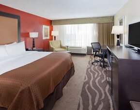 Bright guest room with natural light, workspace, and king bed at Holiday Inn Downtown Shreveport.