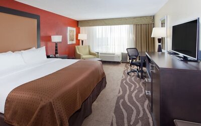 Bright guest room with natural light, workspace, and king bed at Holiday Inn Downtown Shreveport.