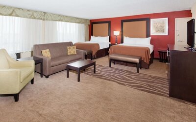 Double queen guest room with workspace and modern furnishings at Holiday Inn Downtown Shreveport.