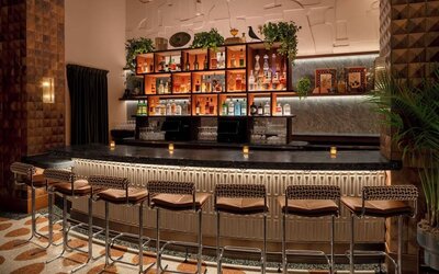 Stylish cocktail bar with ambient lighting and upscale seating at Hyatt Union Square New York.
