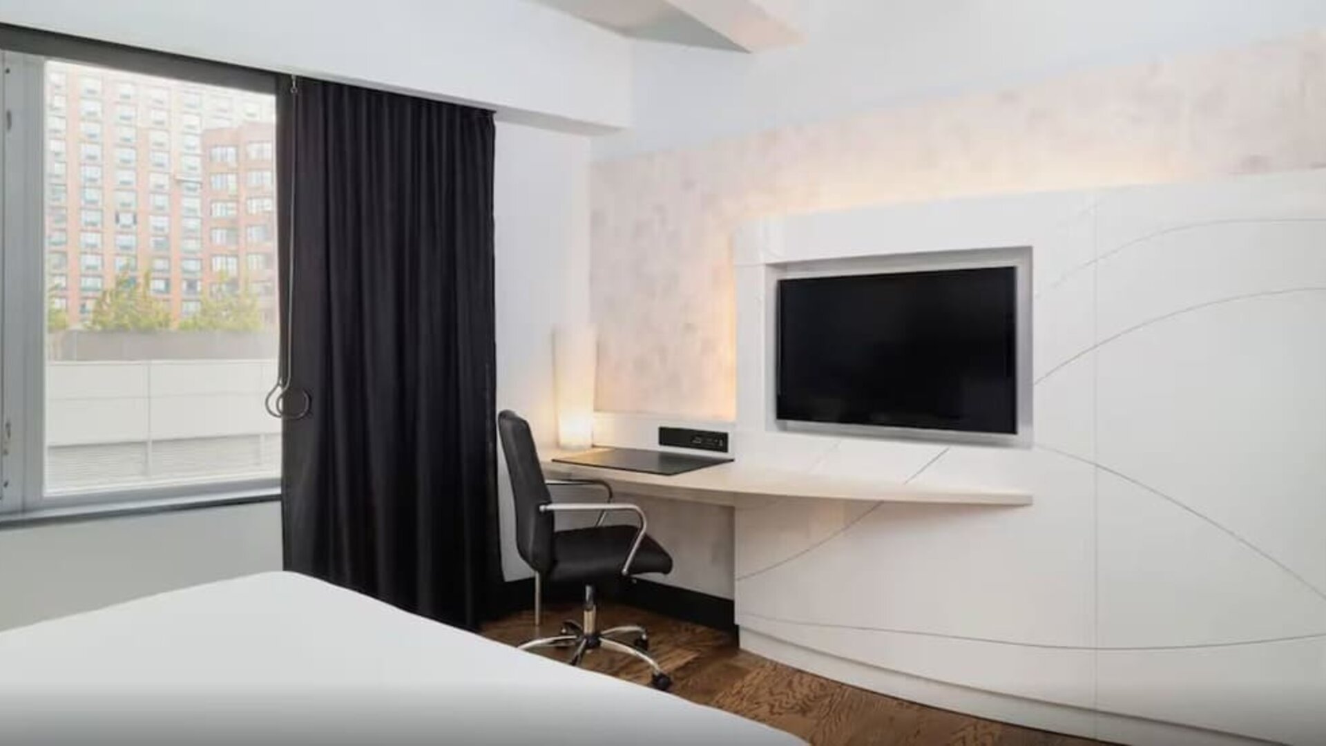 Guest room workspace with mounted television and modern desk setup at Hyatt Union Square New York.