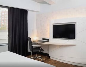 Guest room workspace with mounted television and modern desk setup at Hyatt Union Square New York.