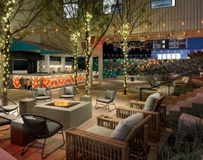 Outdoor patio lounge with fire pit and ambient lighting at Hotel Studio Allston.