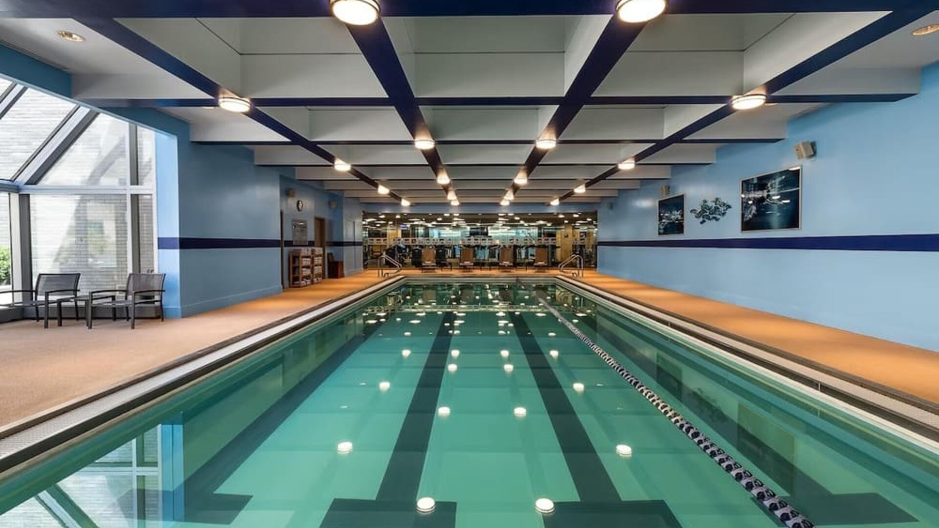 Indoor swimming pool with lap lanes and adjacent fitness area at Hyatt Regency Boston.