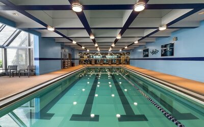 Indoor swimming pool with lap lanes and adjacent fitness area at Hyatt Regency Boston.