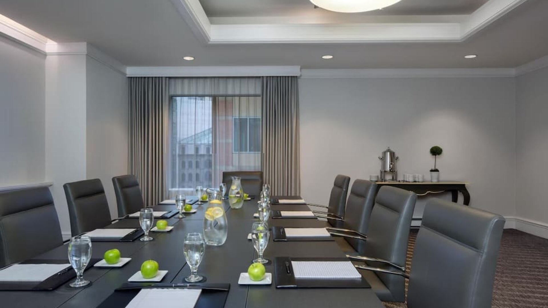 Executive boardroom with conference table setup, leather chairs, and natural lighting at Hyatt Regency Boston.
