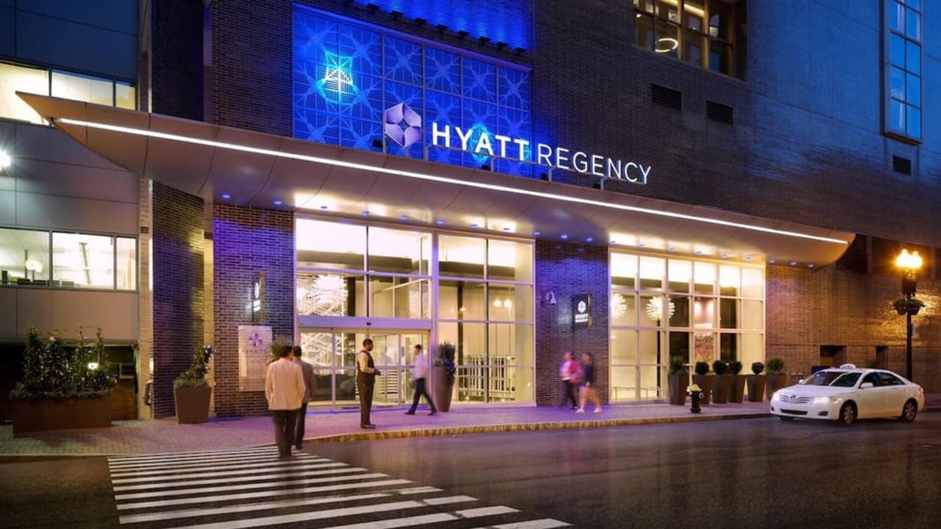 Exterior entrance view of Hyatt Regency Boston illuminated at night.