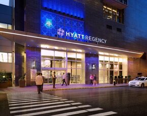 Exterior entrance view of Hyatt Regency Boston illuminated at night.