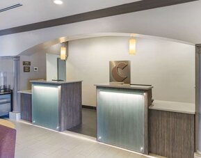 Modern reception desk area with illuminated counters and contemporary finishes at Comfort Inn & Suites Port Charlotte-Punta Gorda.