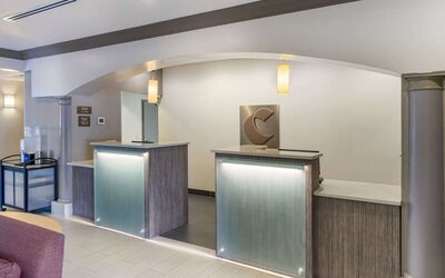 Modern reception desk area with illuminated counters and contemporary finishes at Comfort Inn & Suites Port Charlotte-Punta Gorda.