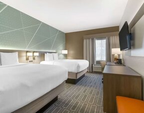Double queen guest room with modern furnishings and spacious layout at Comfort Inn & Suites Port Charlotte-Punta Gorda.