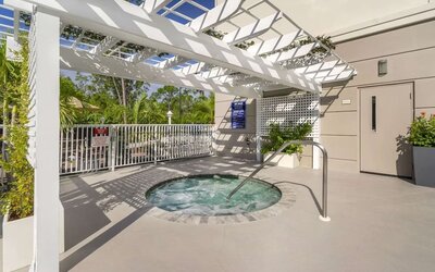 Outdoor hot tub beneath a shaded pergola at Comfort Inn & Suites Port Charlotte-Punta Gorda.