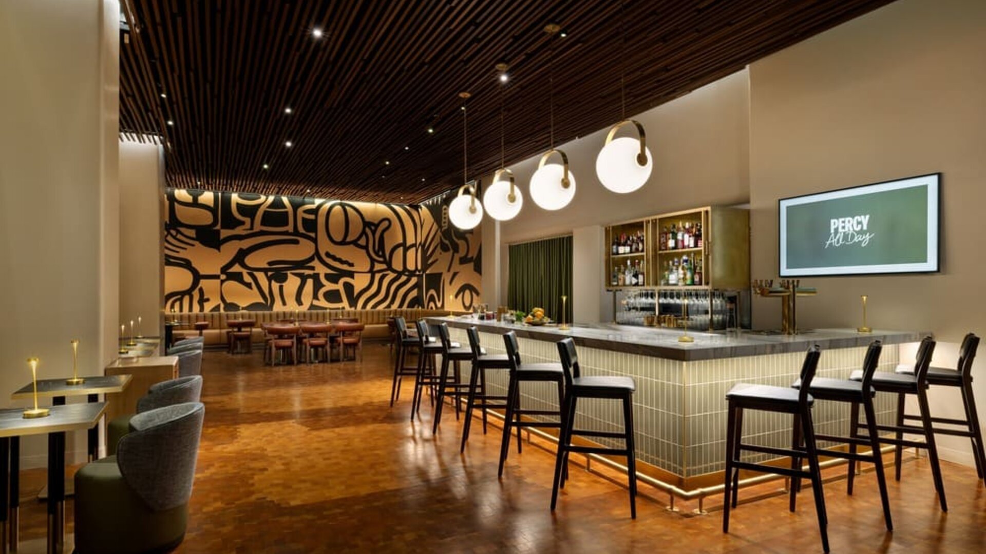 Sophisticated cocktail bar area with elegant seating, warm lighting, and artistic interior design at Row NYC.