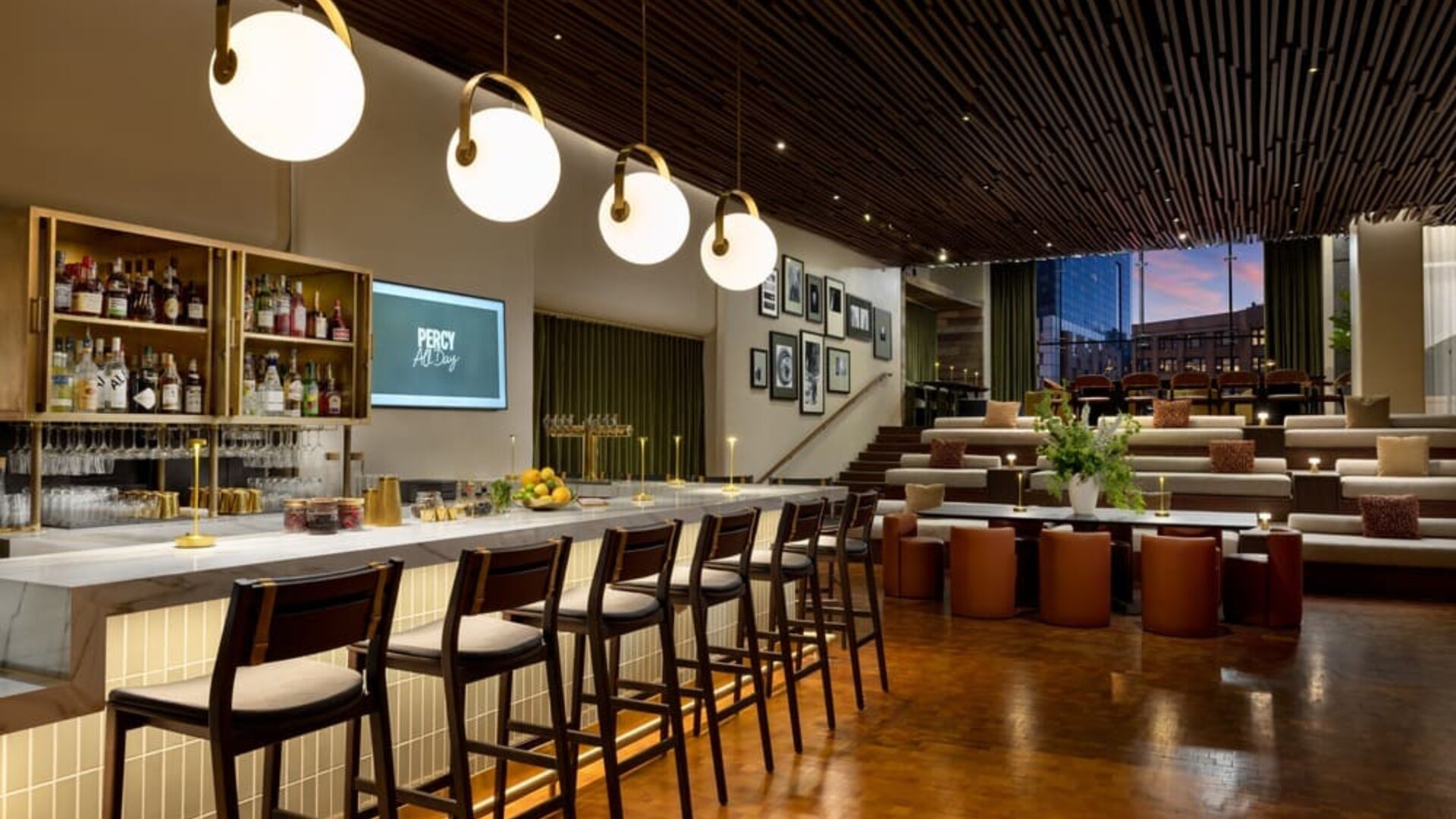 Stylish hotel bar and lounge area with contemporary lighting, upscale seating, and modern décor at Row NYC.