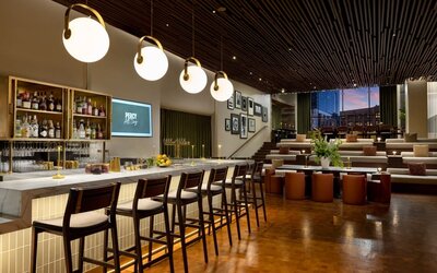 Stylish hotel bar and lounge area with contemporary lighting, upscale seating, and modern décor at Row NYC.